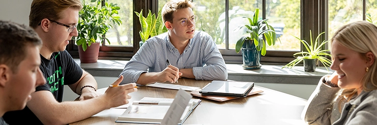 students at table by sunny window