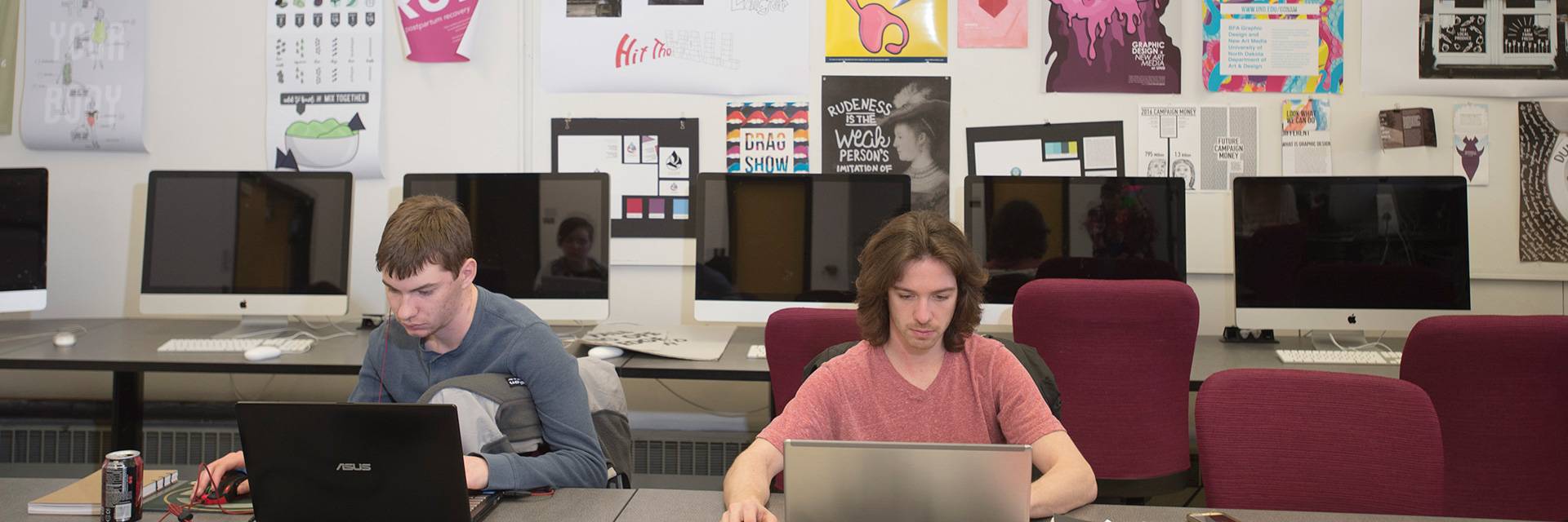 two students working on graphic design in UND classroom