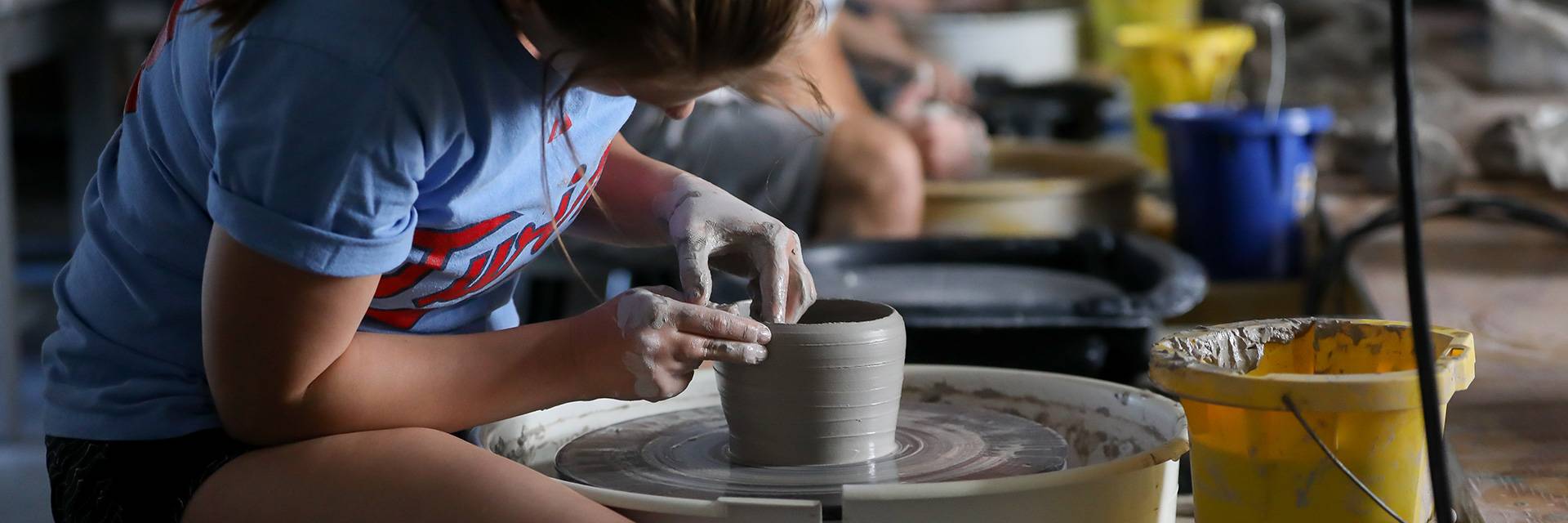 working on pottery in UND classroom
