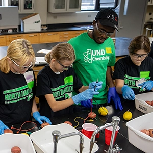 middle school students conducting chemistry experiments in a lab