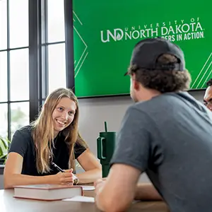 student studying on laptop in coffehouse