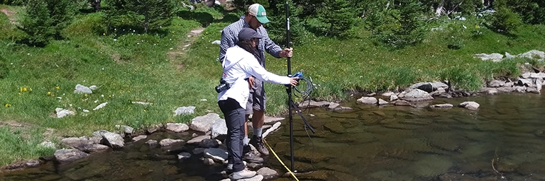 Students taking measurements in a stream.