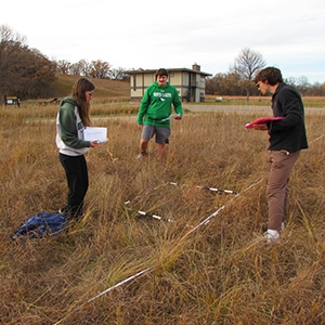 students taking measurements outside