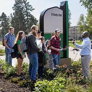 students outside with instructor 