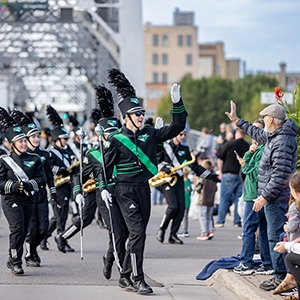 marching band member high fives spectator